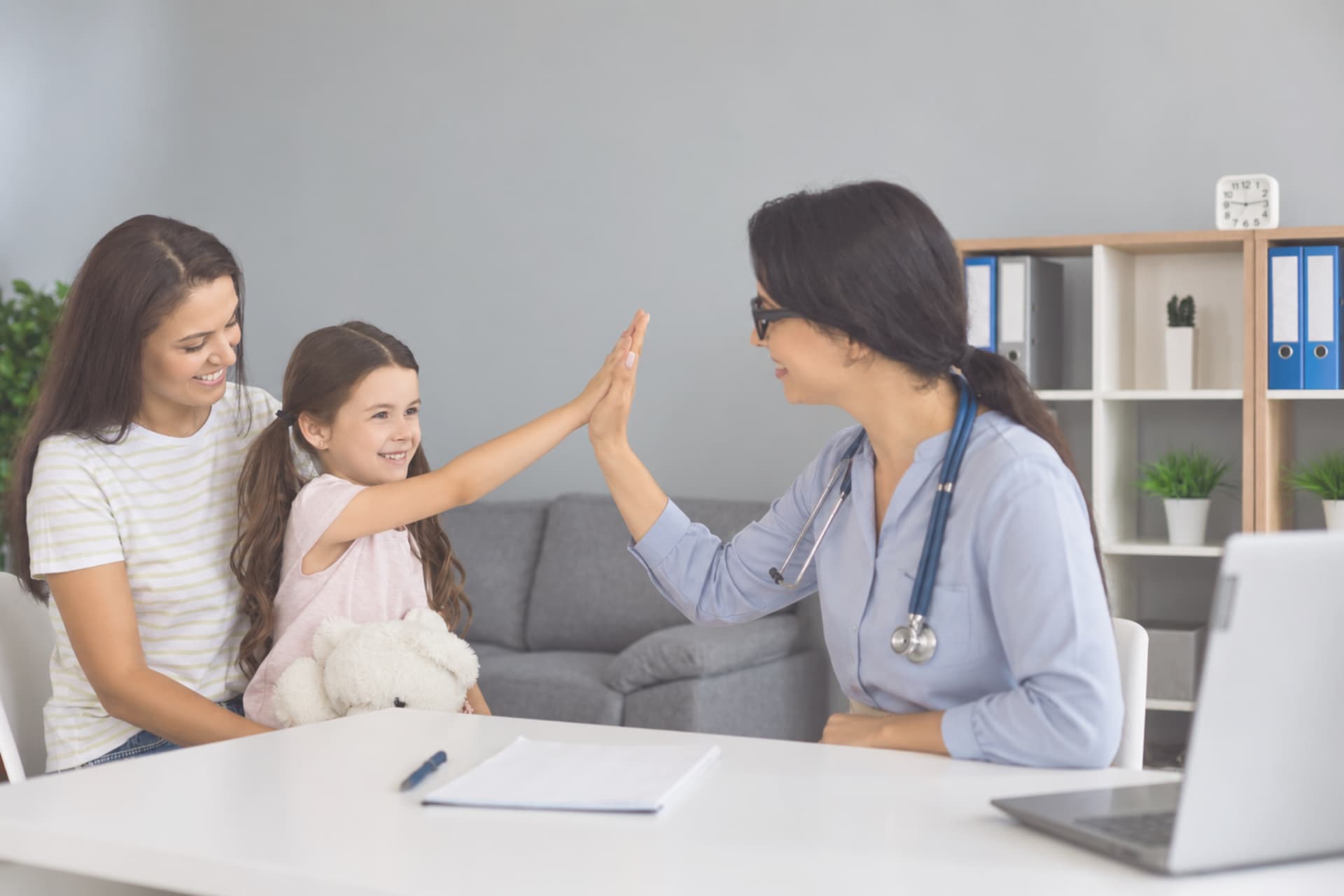 GP connecting with a young patient and her mother