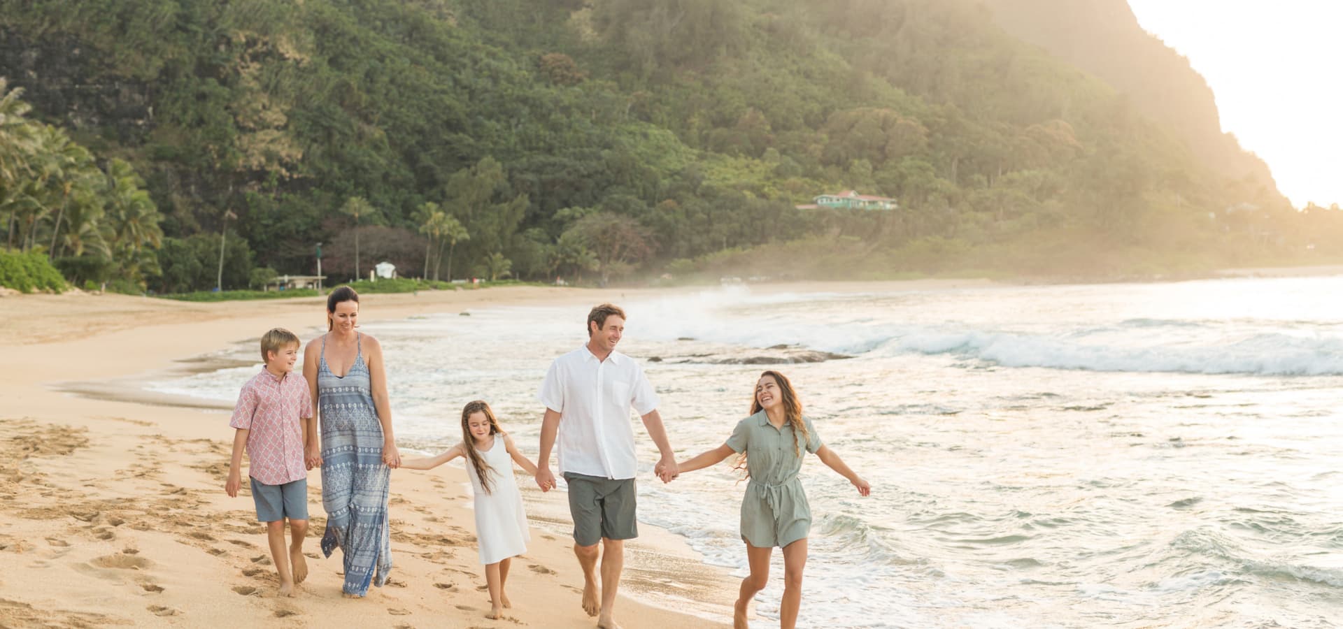 Family walking together along the coast