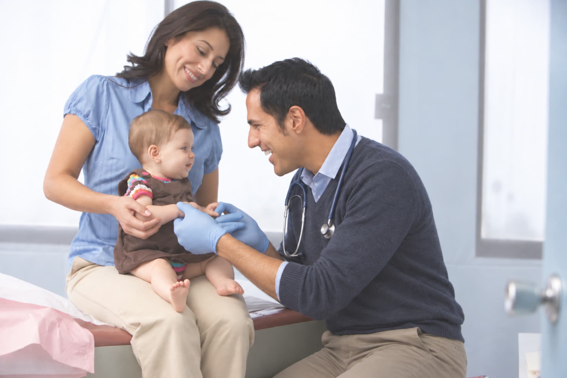 GP caring for a baby during a family consultation
