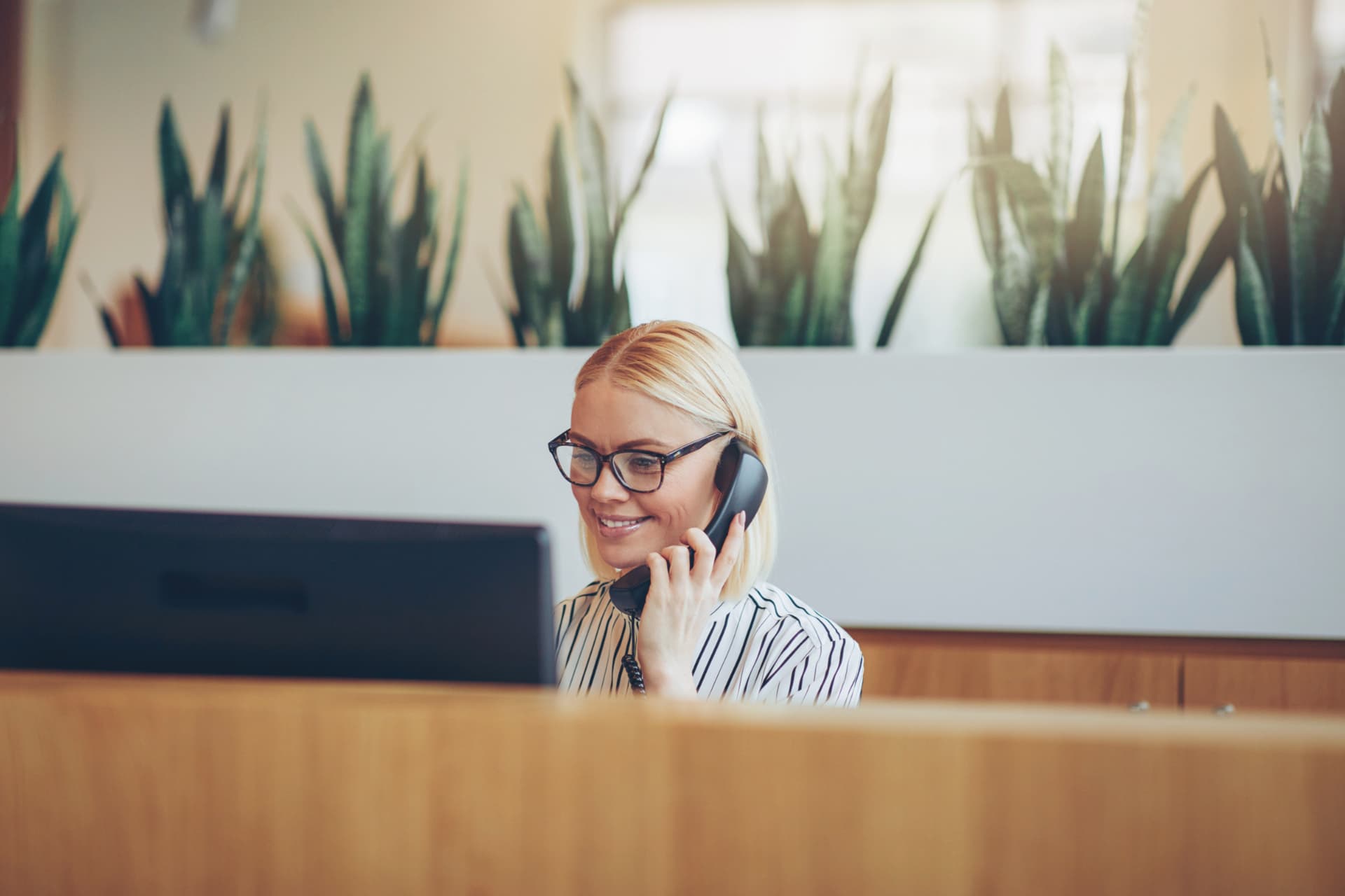 Receptionist speaking on the phone in a modern practice